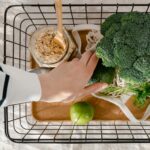 Climate conscious shopper with sustainable products in shopping basket thanks to carbon footprint labels